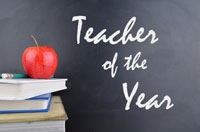 Teacher of the year written on chalkboard with books and apple