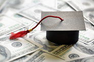 Stock photo of graduation cap on $100 bills.