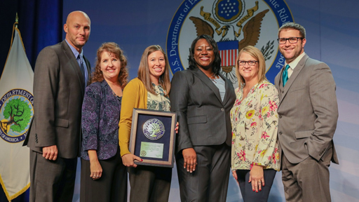 Images of representative from Robert Bennis Elementary being presented award.