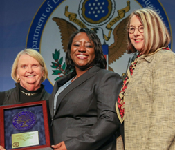 Images of representative from Robert Bennis Elementary being presented award.
