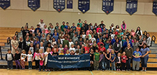 image of Wall Elementary student body and staff holding banner that has text Wall Elementary National Title 1 Distinguished School.