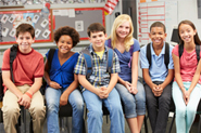 Stock photo of kids sitting in classroom.
