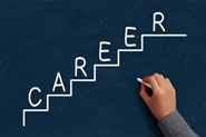 stock photo of person writing word career in steps on the chalkboard.